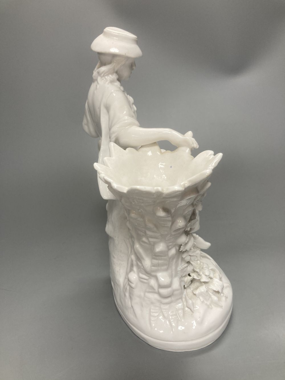 A pair of John Bevington bone china figures, gardener and female companion, 21.5cm